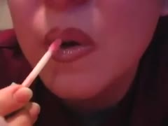Beautiful, youthful lips of a charming adolescent of legal age using lip gloss and lipstick